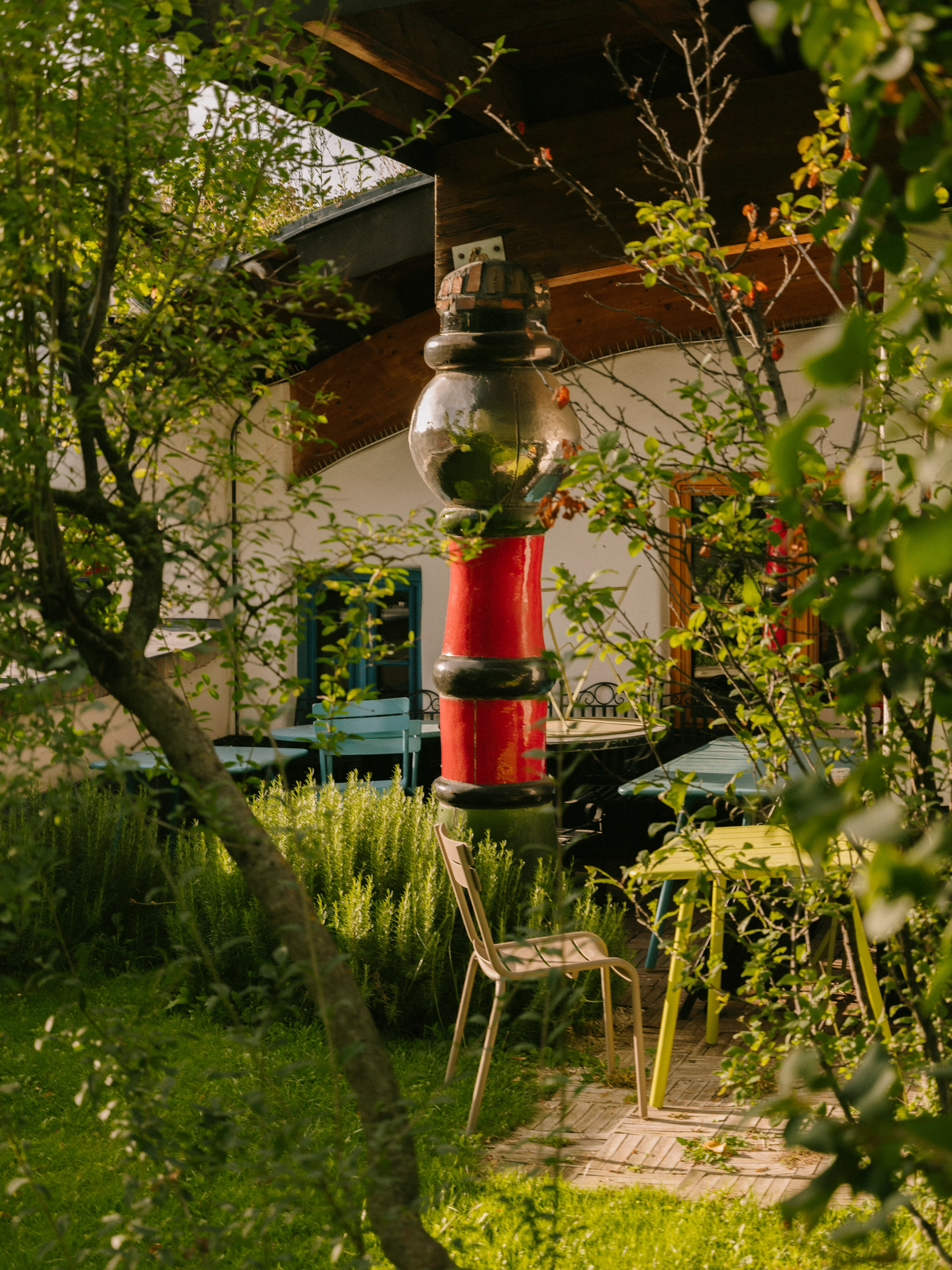 Gartenansicht mit Stuhl und roten Pfosten